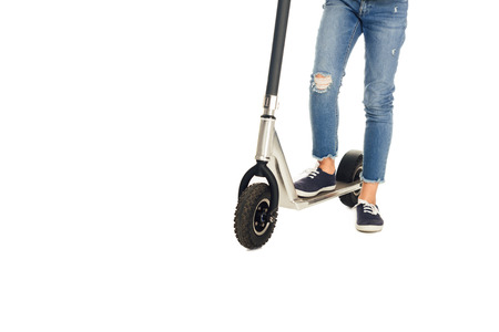 cropped shot of child riding scooter isolated on white