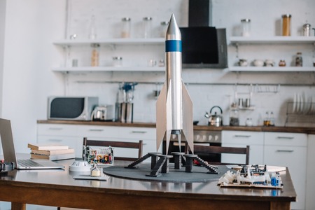 rocket model and tools for engineering on table in kitchenの写真素材