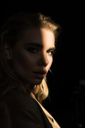 side view of beautiful and stylish model looking at cameraの写真素材