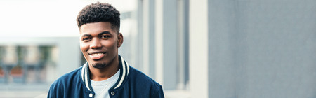 portrait of smiling african american man in stylish bomberの写真素材