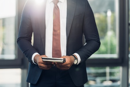 cropped shot of african american businessman with notebook in conference hallの写真素材