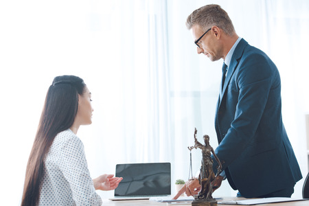 lawyer and young female client using laptop in officeの写真素材
