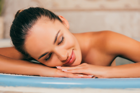 Woman relaxing with closed eyes at spa salonの写真素材