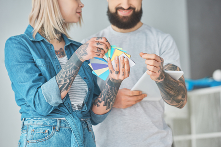 Cropped shot of happy young couple choosing colors for house repairの写真素材