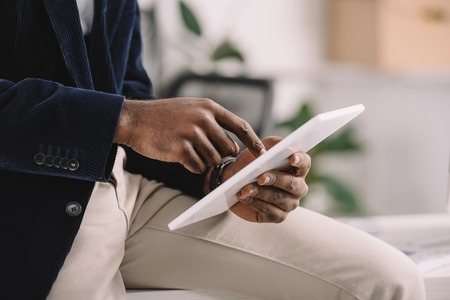 Cropped view of African American businessman using digital tabletの写真素材