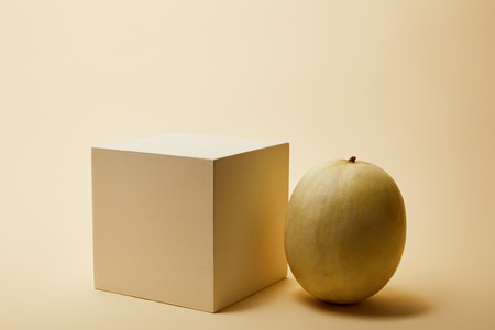 close-up shot of ripe melon and cube on beige surfaceの写真素材