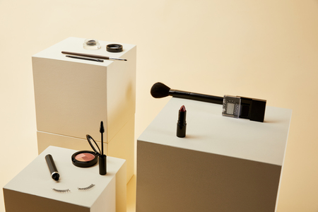 various makeup accessories kit on beige cubesの写真素材