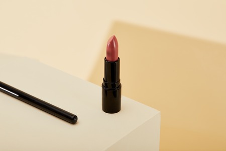 close-up shot of lipstick standing on beige surfaceの写真素材