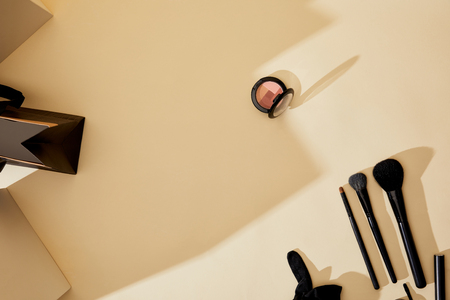 top view of makeup supplies lying on beige tabletopの写真素材