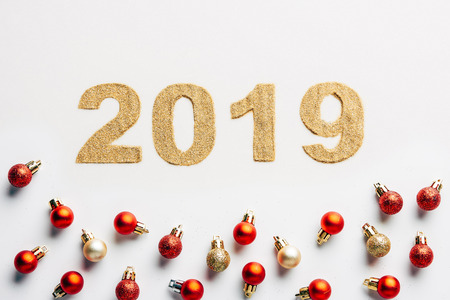 top view of 2019 year golden sign and christmas balls on white backgroundの写真素材
