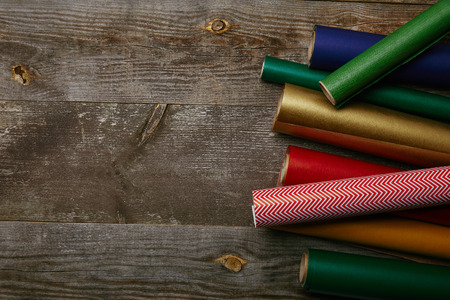 top view of arranged wrapping papers of different colors on wooden backgroundの写真素材