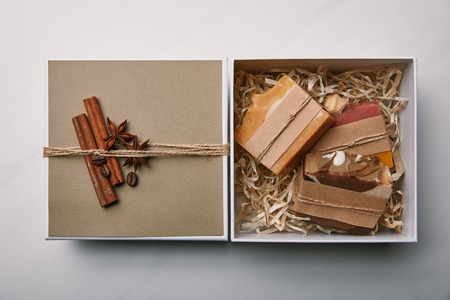 top view of box with soap inside on white marble surfaceの写真素材