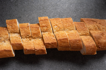 top view of cut baguette on grey surfaceの写真素材