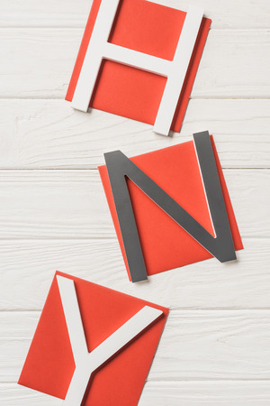 top view of lettering hny ( happy new year) on wooden tableの写真素材