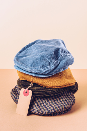trendy caps with sale tag on beigeの写真素材