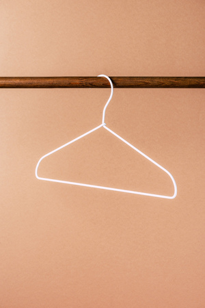 one empty white hanger on beigeの写真素材