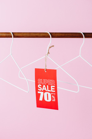 hangers with red super sale tag - seventy percents discount on pinkの写真素材