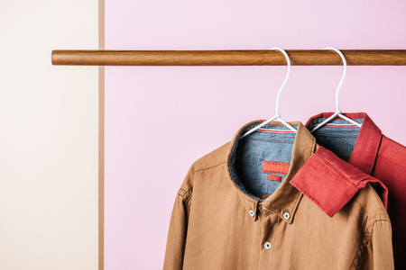 closeup of trendy shirts on hangers, fashion industry