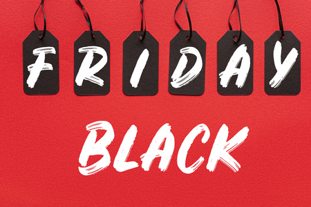 black sale tags isolated on red with black friday letteringの写真素材