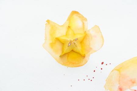 top view of yummy yellow star fruit on white surface with yellow watercolorの写真素材