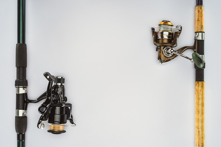 top view of two arranged fishing rods isolated on white, minimalistic conceptの写真素材