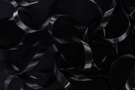 top view of black glossy ribbons as background for black fridayの写真素材