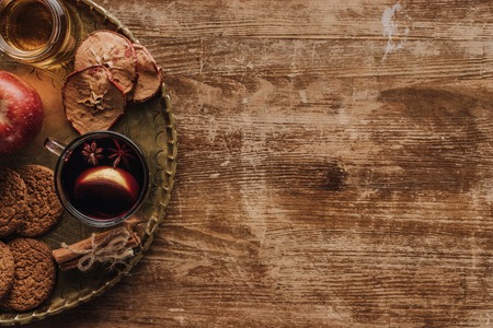 elevated view of mulled wine in cup and cookies on wooden tabletop, christmas conceptの写真素材