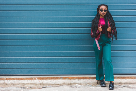 full length view of beautiful stylish young african american woman looking at cameraの写真素材