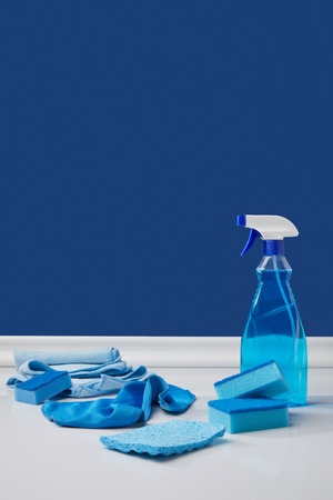 blue spray, rags and washing sponges for spring cleaningの写真素材