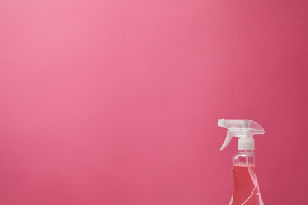 spray bottle with antiseptic liquid isolated on pinkの写真素材