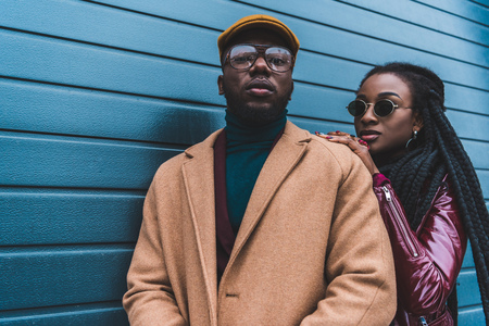 fashionable young african american couple in stylish outfit posing together outsideの写真素材