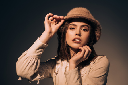 portrait of fashionable woman in hat looking at cameraの写真素材