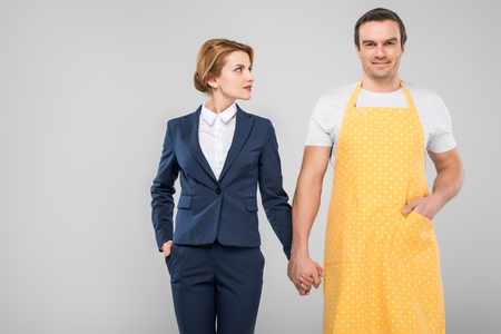 businesswoman and male householder holding hands, feminism concept, isolated on greyの写真素材