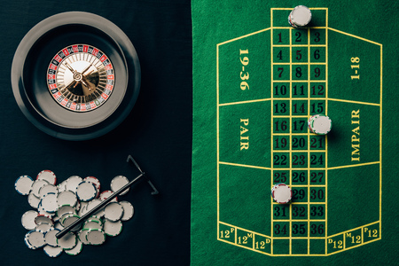 Gambling concept with chips and roulette on casino tableの写真素材