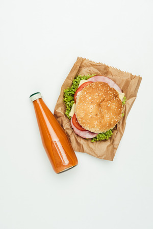 top view of juice with burger on paper bag isolated on whiteの写真素材