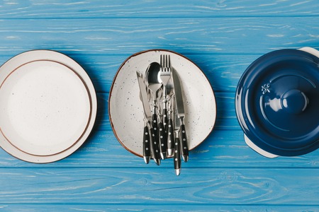 top view of plates pan on blue table