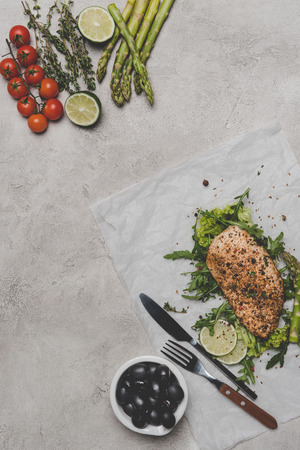 top view of healthy meal with baked meat and vegetables on greyの写真素材