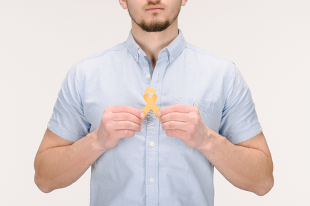 Partial view of man with yellow  ribbon isolated on white background, world health day conceptの写真素材