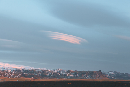 beautiful snow-covered rocky mountains and cloudy sky in icelandの写真素材