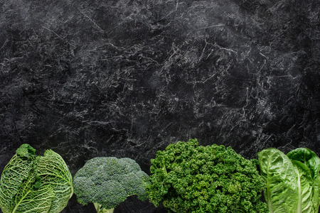 Top view of broccoli, savoy cabbage and parsley on concrete table, healthy eating conceptの写真素材