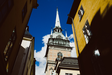 Low angle view of traditional houses and cathedral in Stockholm, Swedenの写真素材