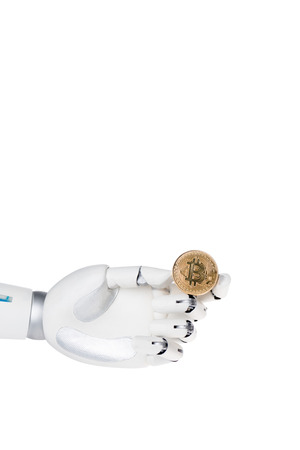 Robot hand holding golden bitcoin isolated on white backgroundの写真素材