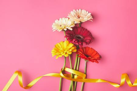 Bouquet of colorful Gerbera flowers tied with yellow ribbon, mothers day conceptの写真素材