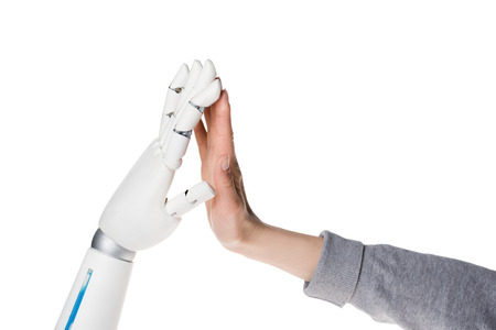 Cropped shot of robot and human making high five isolated on white backgroundの写真素材