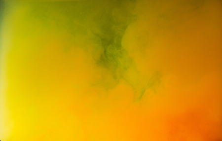 Abstract bright yellow and orange ink explosion, artistic background