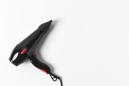 Top view of black hair dryer, on white backgroundの写真素材