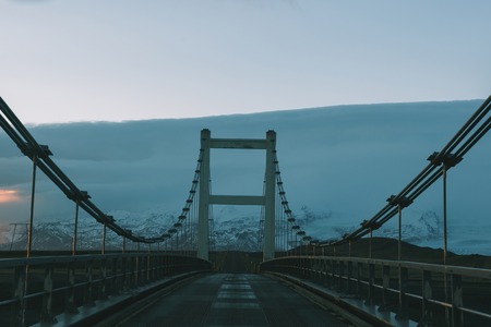 Driving on bridge at cold sunset in Icelandの写真素材