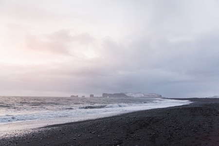 Majestic seacoast with wavy sea and cliffs, Vik Dyrholaey, Reynisfjara beach, Icelandの写真素材