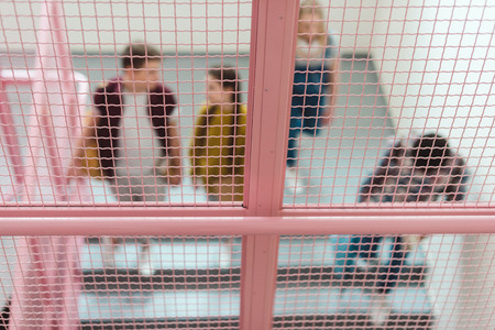 Blurred shot of group of high school students on stairs of school corridor
