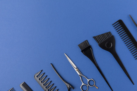 Diagonal composition with hairdressing tools, isolated on blue backgroundの写真素材